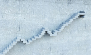 Karriere_Stufen Aus einer grauen Wand ragen Stufentreppen hervor.